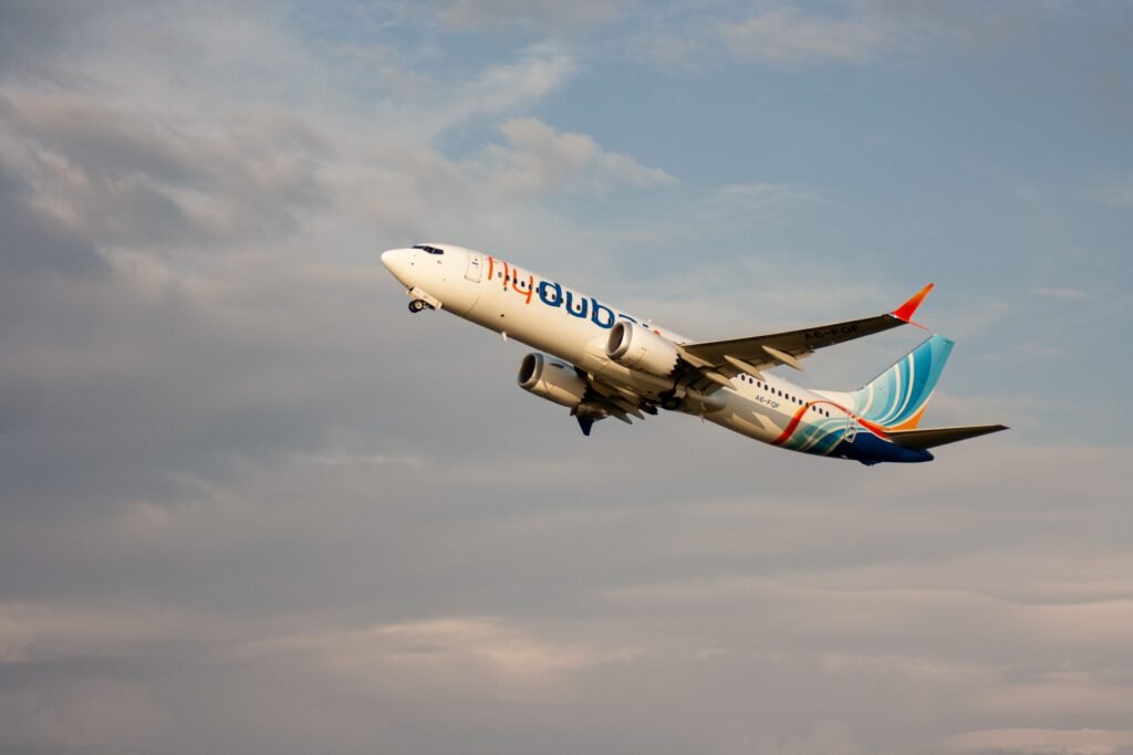 Flydubai Boeing 737 passenger jet taking off at sunset in Batumi, Georgia with clear skies.