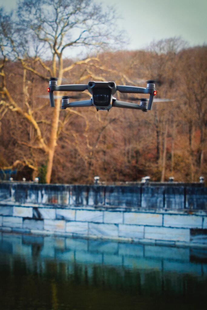 Aerial drone hovering over a reflective pond in a scenic Istanbul park.